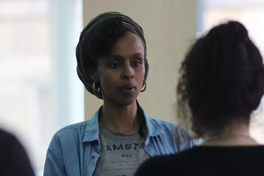 Photo of Yusra Warsama wearing a headscarf and hooped earrings