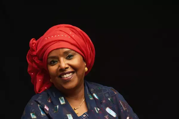 Headshot of Sahra Halgan smiling on a black background