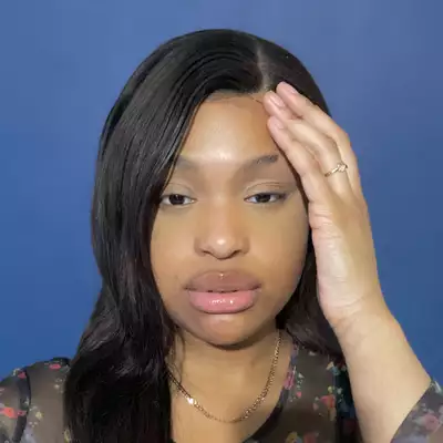 A photograph of Benedicte Tee looking straight at the camera