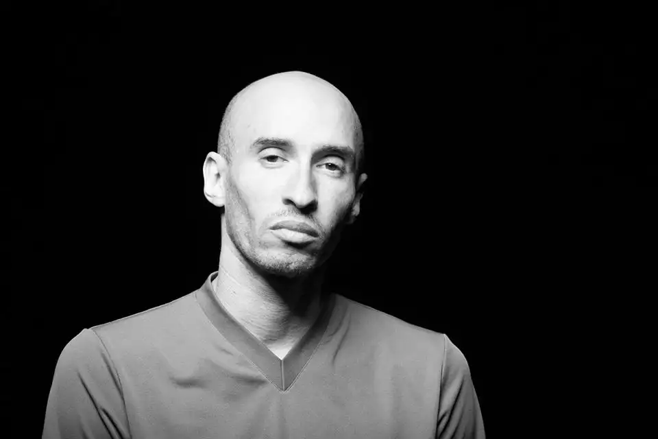 A black and white headshot of Darren Pritchard