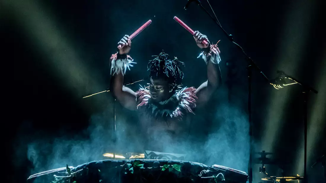 Photo of a performer playing drums on stage