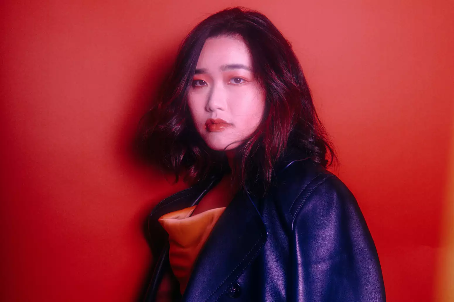 Portrait of Edane against a red background