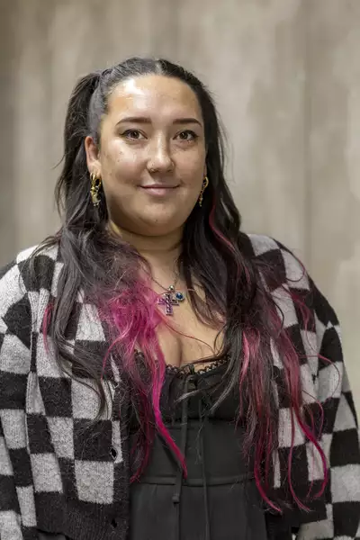Portrait photograph of Emma Naughton wearing a black and white chequered jacket