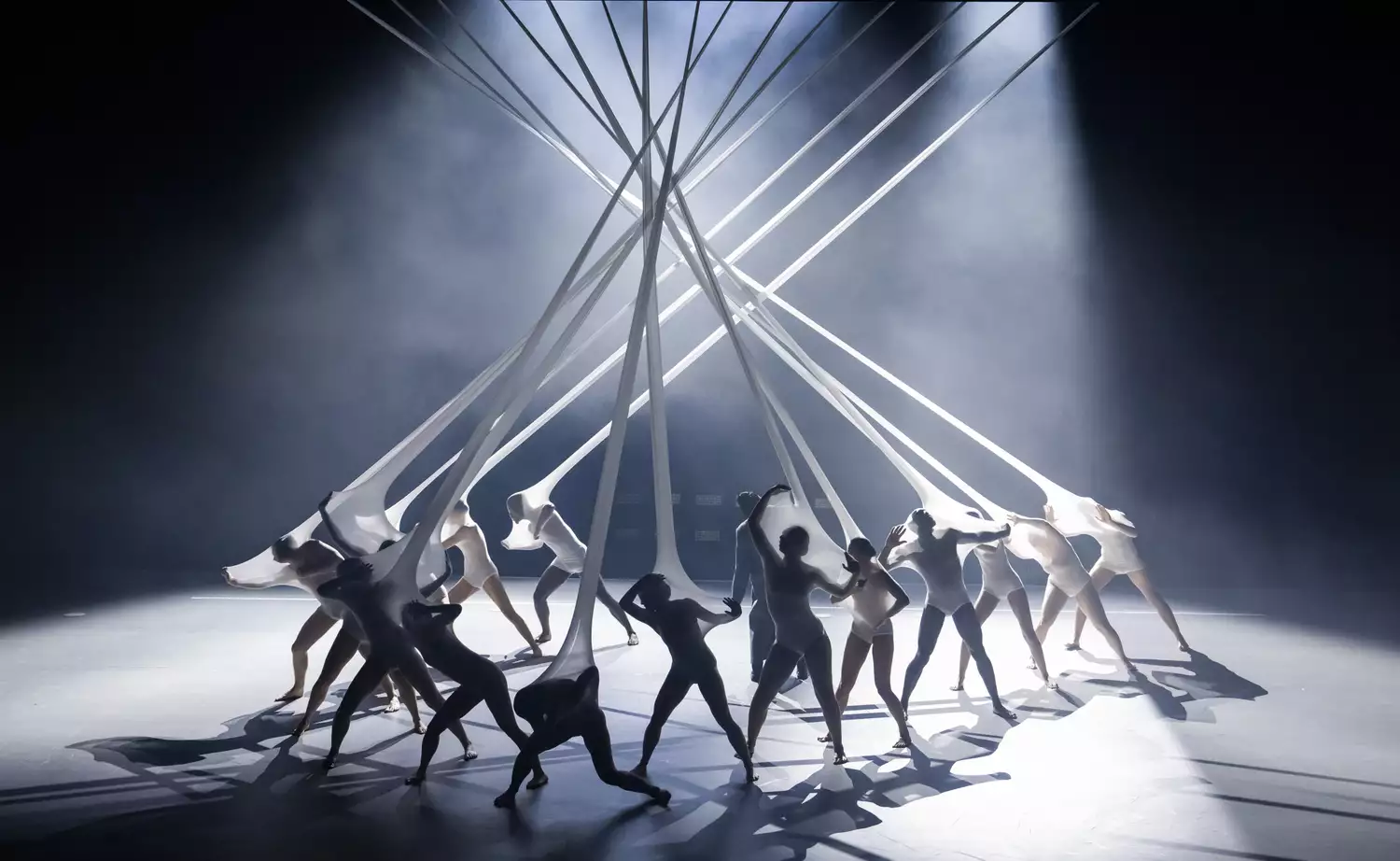 Dancers performing inside a loom on stage for Free Your Mind