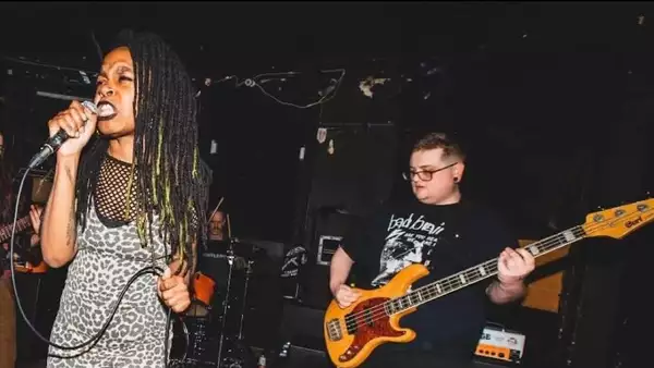 Photo of two members of Gurnal Gadafi performing on stage