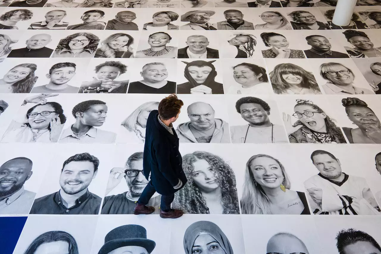 Someone walking over the black and white Inside Out portraits on the ground