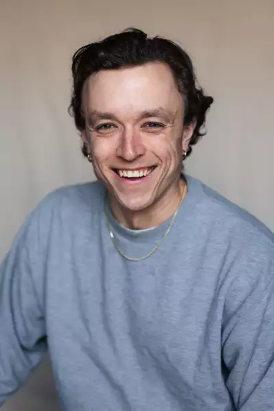Joe Young in a grey sweatshirt and gold chain