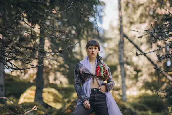 Katarina Barruk in the woods wearing a long purple robe