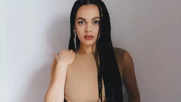 Portrait of Mali Hayes in a cream dress