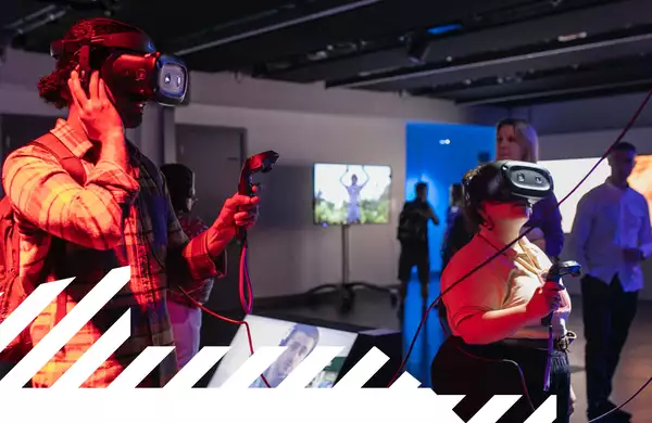 Two people wearing VR headsets