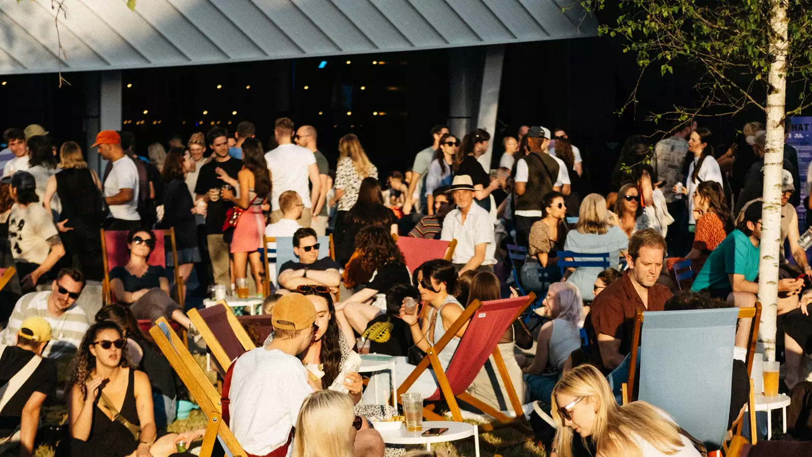 Photo of a busy crowd of people outside Aviva Studios on Festival Square during MIF23