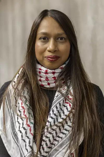 Portait photograph of Niparun Nessa wearing a white patterned scarf