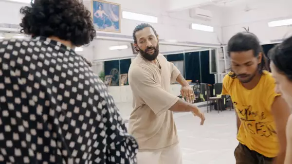 Terence Lewis directing three people in a rehearsal room