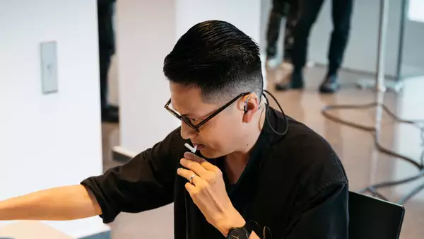 Samson Young in a black top looking to the left