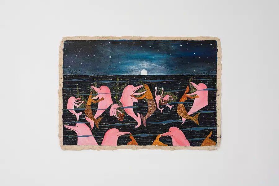 An artwork by Santiago Yahuarcani, showing dolphins and mermaids. The artwork is displayed on a white wall.