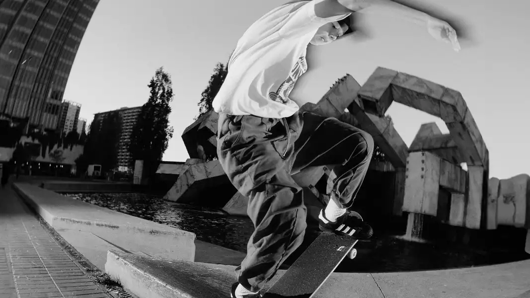 Black and white photograph of a skateboarder mid-trick
