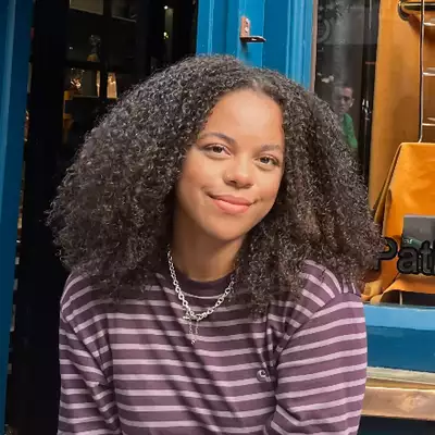 Square headshot of Rachel Morgan smiling and wearing a purple striped top