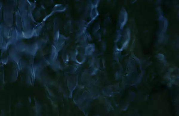 This image has an abstract, fluid-like pattern with dark blue and black tones, creating a sense of flowing water or rippling textures.