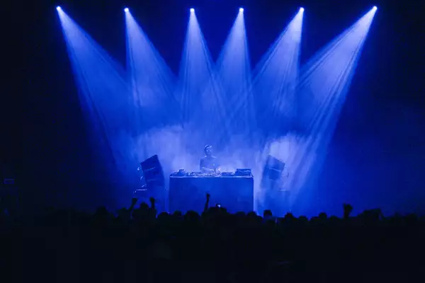 Laurent Garnier performs at a gig under blue stage lights